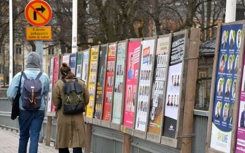 människor går förbi valaffischer