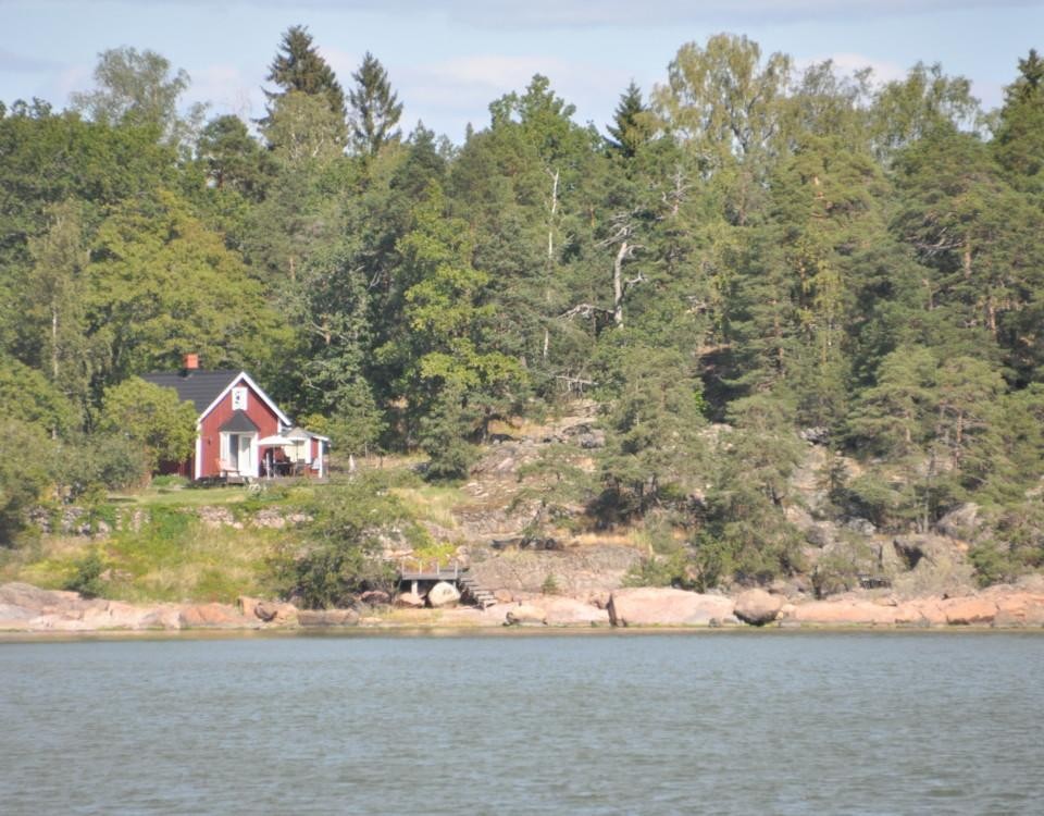 sommarstuga invid en strand med klippor