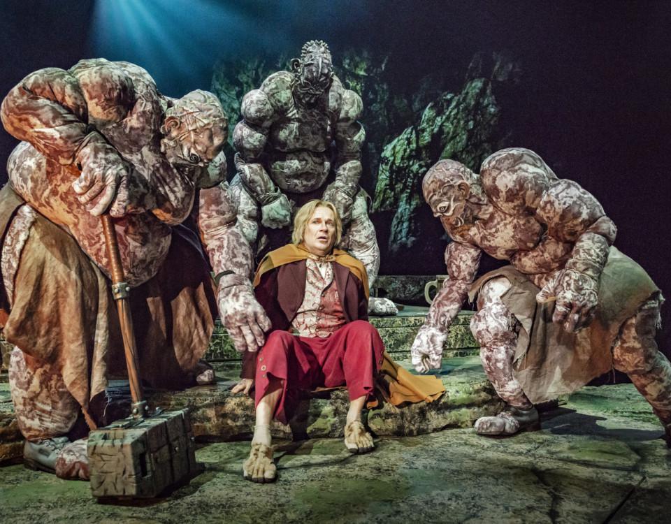en scen ur teaterföreställningen Hobbit med tre troll runt omkring