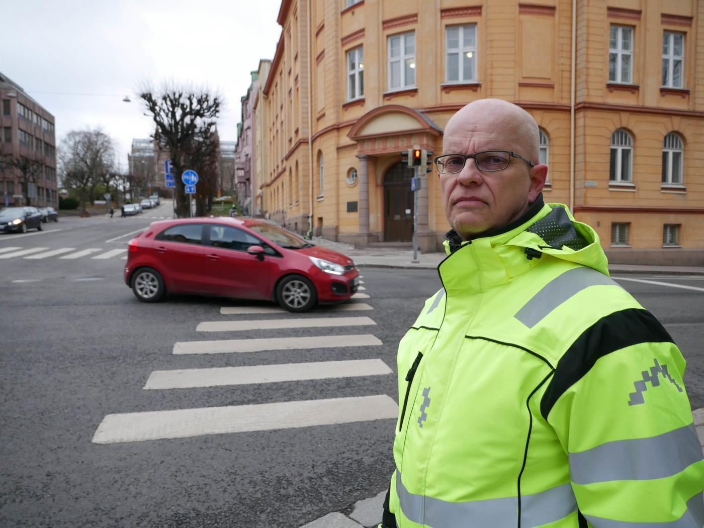 en man står vid ett trafikljus