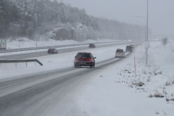 Bilar på en snöig väg.