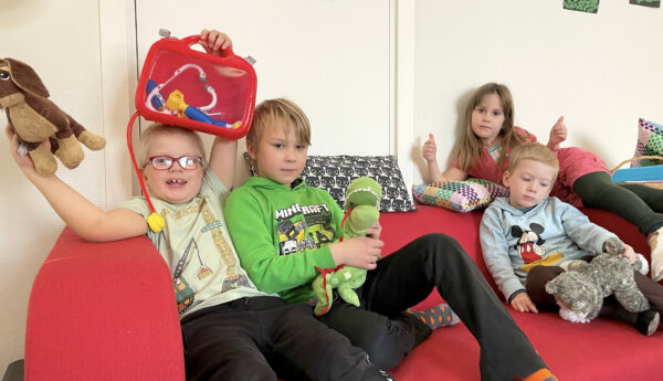 Fyra barn i en röd soffa